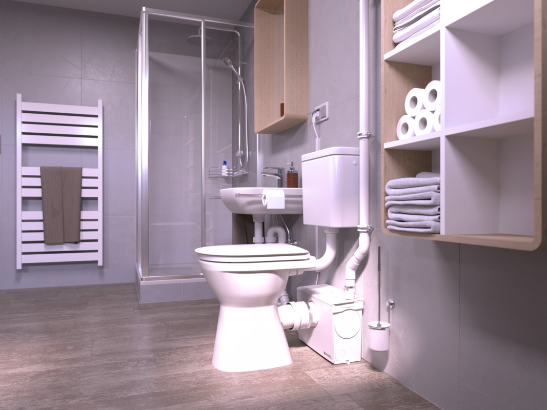 Vue d'installation du Minilift M WC, deuxième perspective Gros plan sur des toilettes, derrière lesquelles se trouve un petit poste de relevage à lequel est également raccordée une douche.